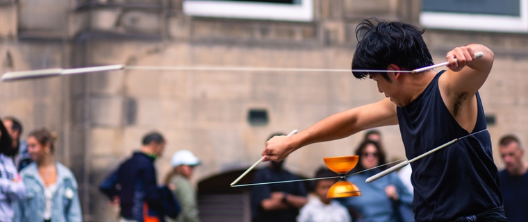 Cheng Yung Tsang facing away locked in concentration - diabolo string slicing the view