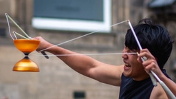 Performer strains to string the diabolo