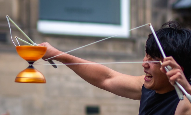 Performer strains to string the diabolo